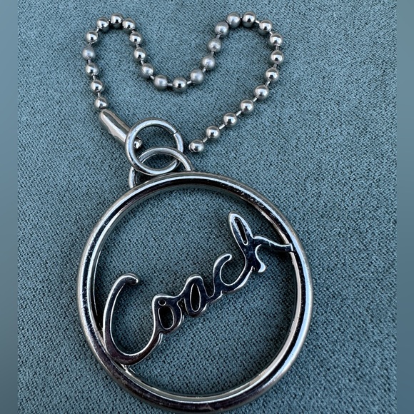Coach Circular Silver Keychain
Coach Silver Circle Keychain – Timeless Elegance - Picture 12 of 16